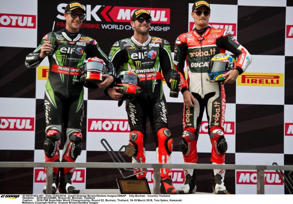 Tom SYkes race one victor on podium with Jonathan Rea and Chaz davies
