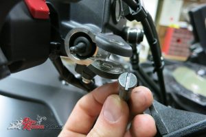 Here's the bolt (right side) removed, and you can see the brake light sensor.