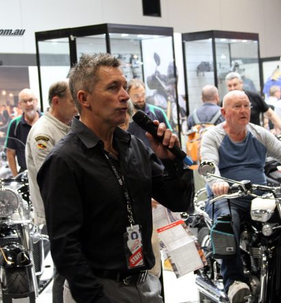 Troy Bayliss introduces the show in front of the Triumph stand