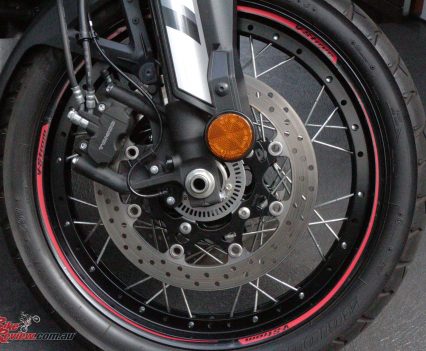 Four-piston Tokico calipers, gripping 310mm floating discs up front.