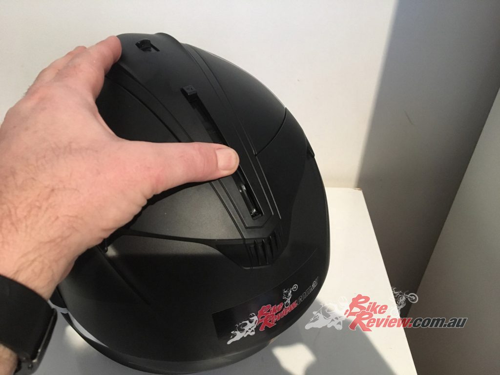 The sun visor lever is located on the top of the helmet. 