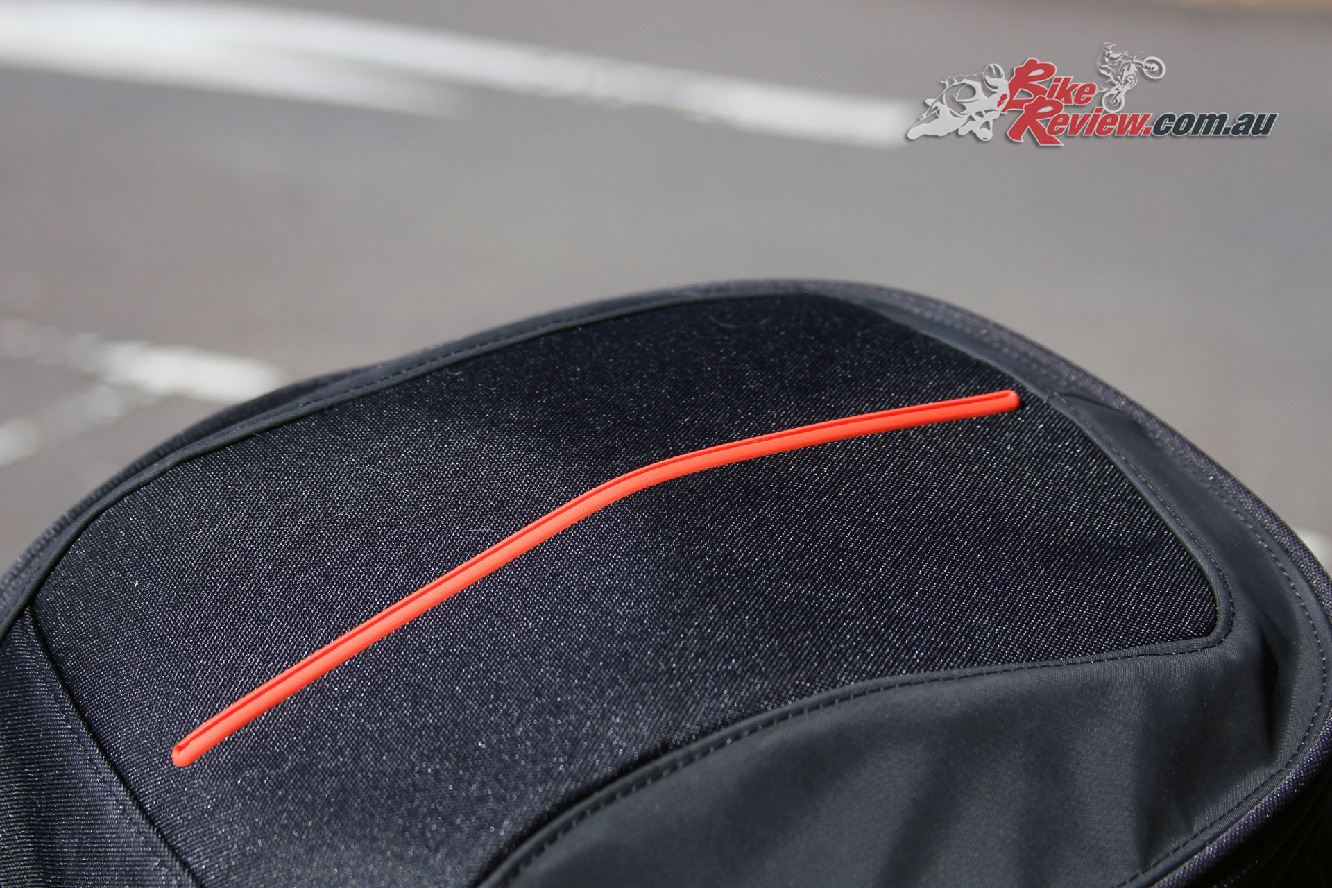 The red stripe across the top of the bike adds a touch of style, while reflective piping helps visibility