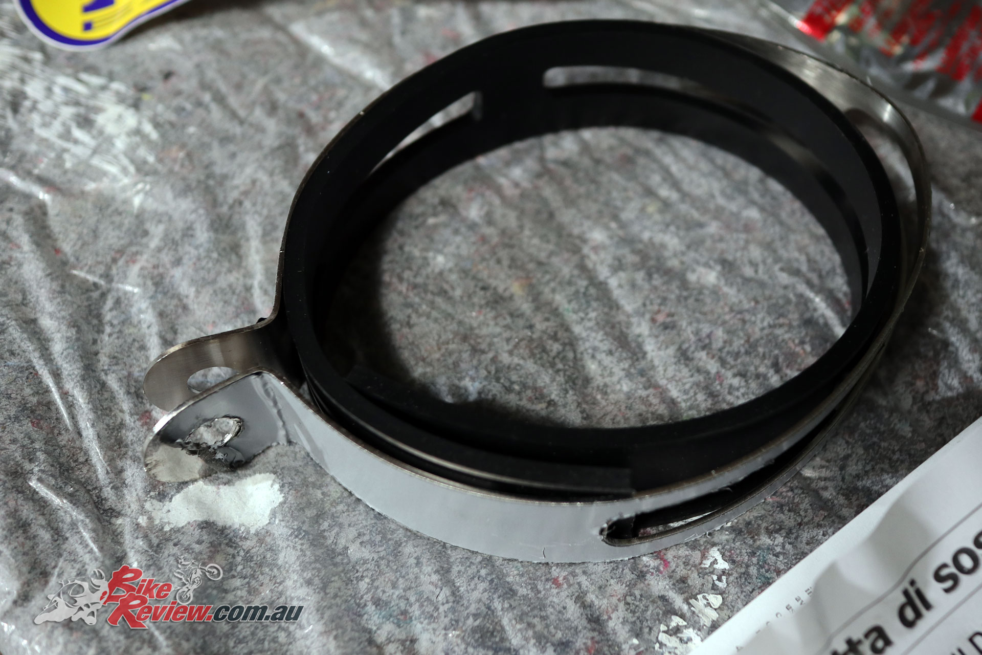 The exhaust clamp comes with excess rubber that prevents it damaging the exhaust and helps it grip the muffler body, but needs trimming to size