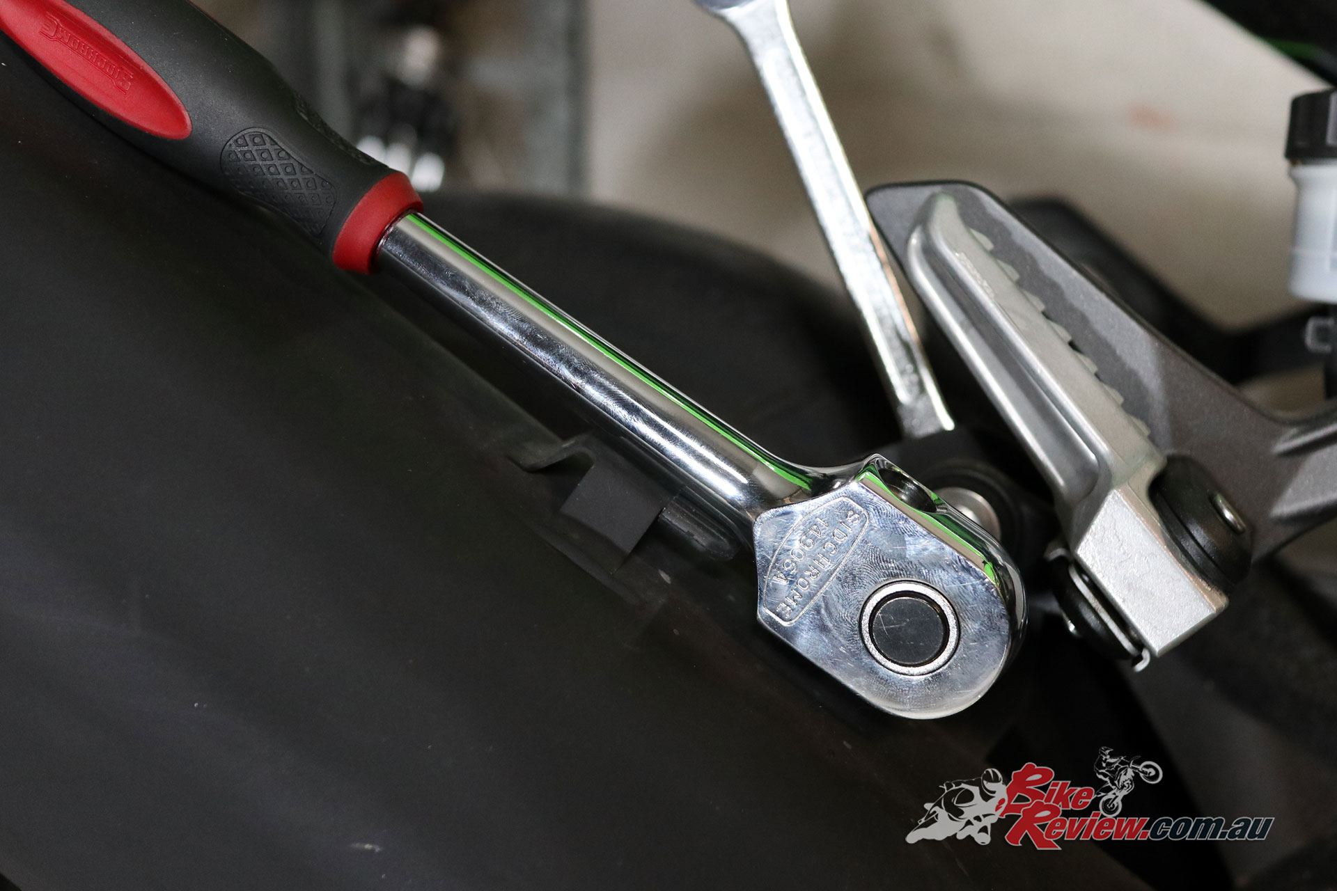 Undo the stock exhaust's mounting point on the pillion hanger