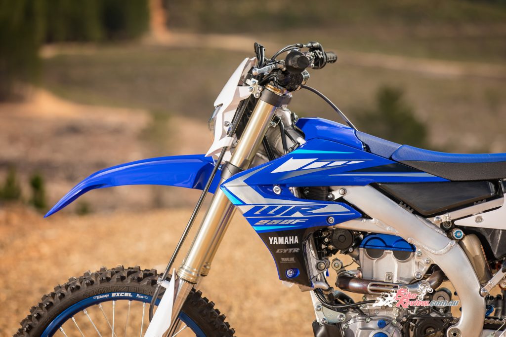 The WR250F runs the same KYB upside-down front forks as the YZ250F but with model-specific enduro settings.