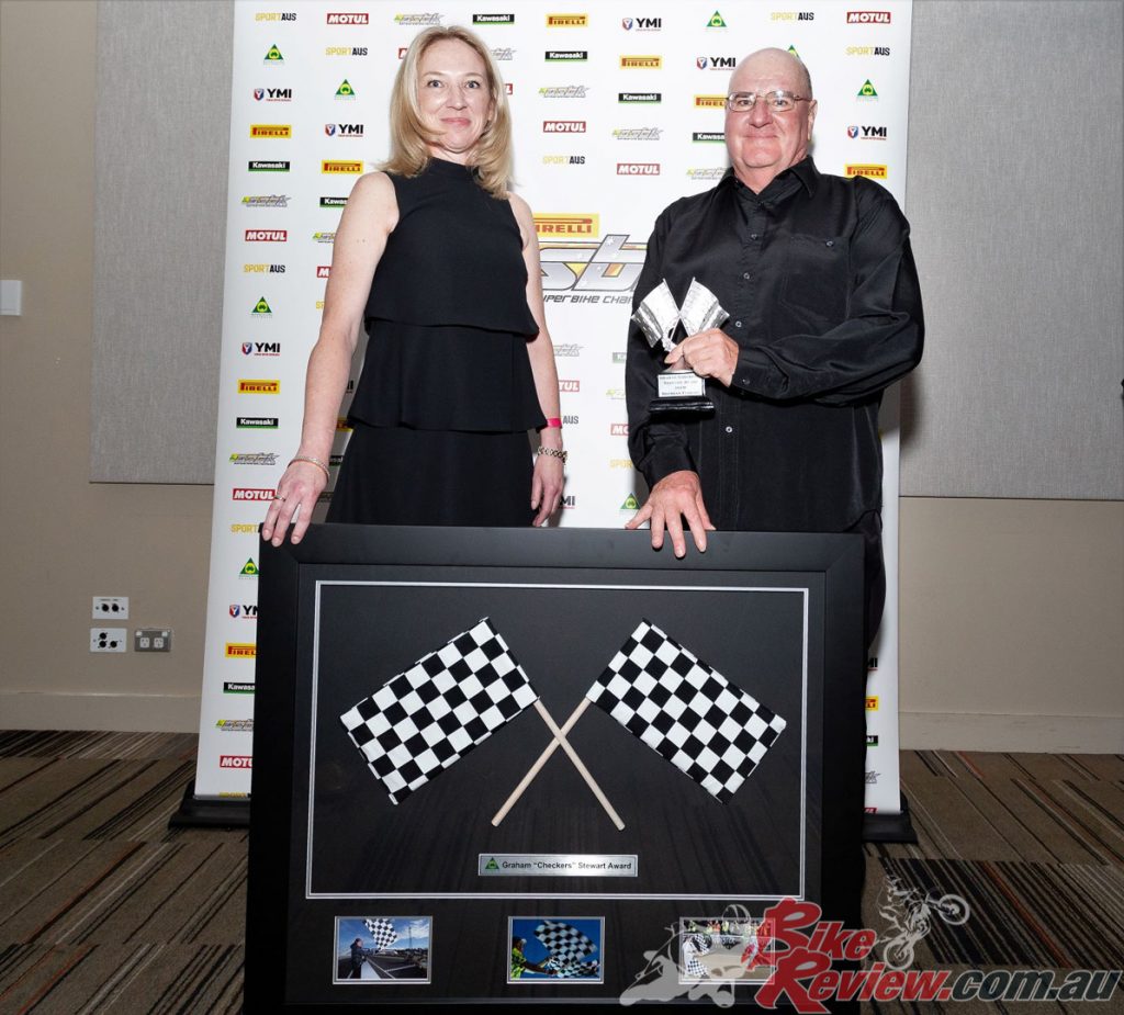 Brendan Ferrari receives the Graham "Checkers" Stewart Award from Evon Stewart, wife of the late Graham Stewart