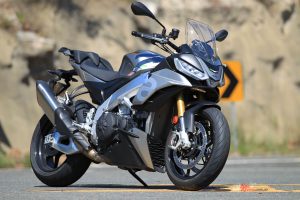 The new $28,830 Tuono V4 1100 has a taller screen and handlebars than the Factory, along with plusher Sachs suspension and lower pillion footpegs plus a more comfy seat.