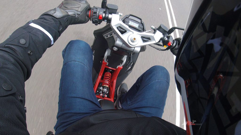 "The forward view is cool, with the alloy top triple-clamp, compact LCD display and the exposed red trellis frame, with the front shock right there between my feet... "
