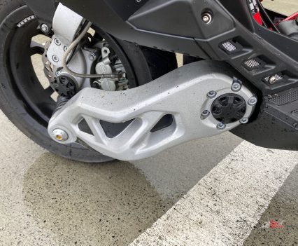 The front swingarm is on the left side and the shock is in the trellis frame sitting between your feet.