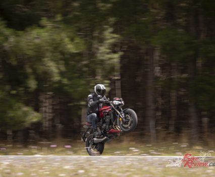 Despite the road-soaked roads, the Street Triple 765RS has no issues getting the power down for a wheelie!