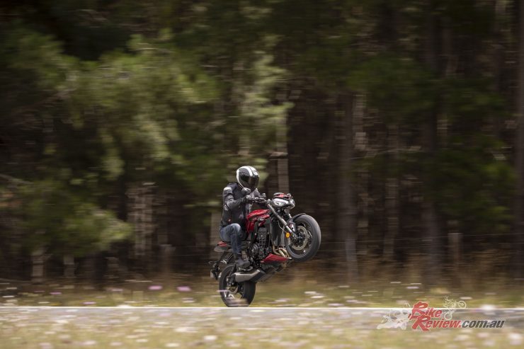 Despite the road-soaked roads, the Street Triple 765RS has no issues getting the power down for a wheelie!