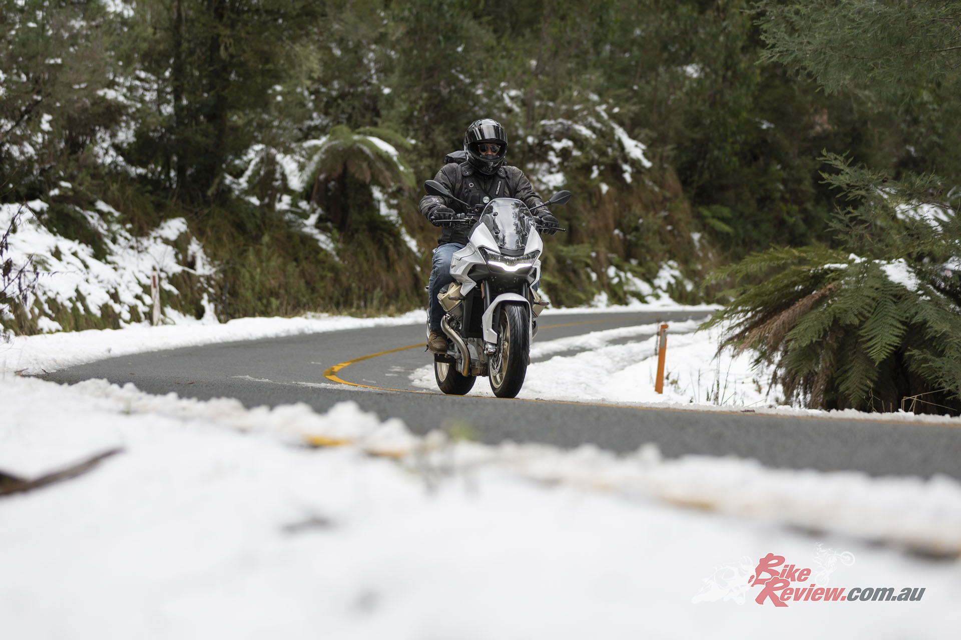 "On the road it's such a confident bike, the tighter the turns the more it feels like a sportsbike, and yet it still manages to deliver a plush ride the entire time. Even as we hit patches of snow, the Guzzi stays planted and the traction control works really well."