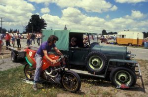 Allan Wylie sitting on the Britten Aero-D-One with Mike Sinclair sitting in the ute.