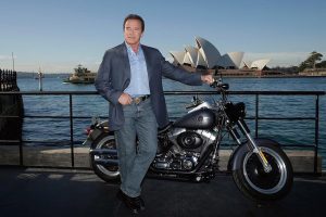 Arnold Schwarzenegger at Sydney Harbour in 2015 with the Terminator 2 Fat Boy Lo prize from Terminator 2 Genisys.