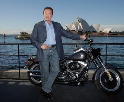 Arnold Schwarzenegger at Sydney Harbour in 2015 with the Terminator 2 Fat Boy Lo prize from Terminator 2 Genisys.