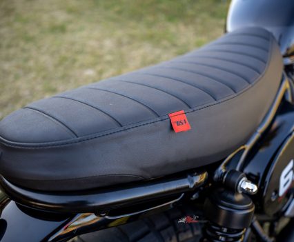 The ribbed bench seat contributes to the bike’s deliberately simple, period-inspired look.