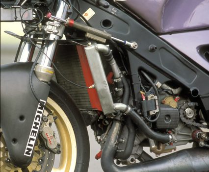 With the fairing removed, the relationship between the V-twin, radiators and twin-spar frame is clearly visible.