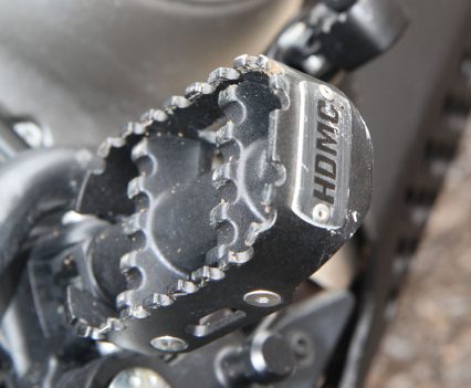 Wide, serrated footpegs provide plenty of purchase when standing in rough terrain.