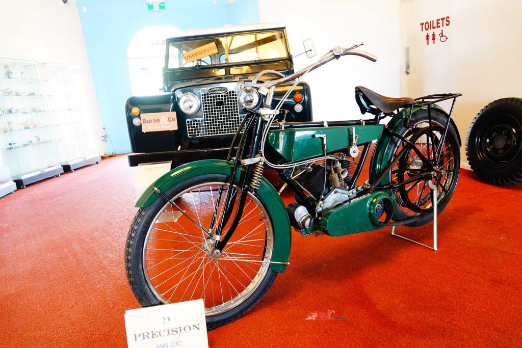 The beautifully restored 1914 Precision fetched $26,000, with a 1959 Land Rover Series II in the background.
